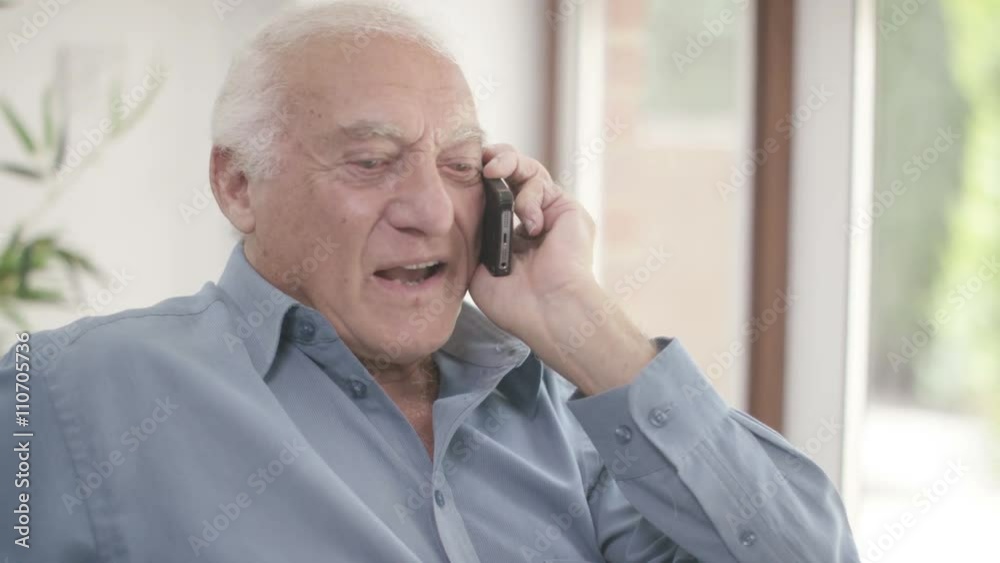 Elderly man in a wheelchair talking on mobile phone Elderly man in a wheelchair talking on mobile phone