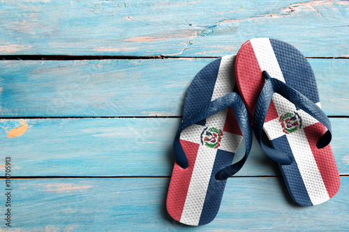Thongs with flag of Dominican Republic, on blue wooden boards