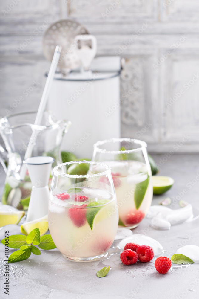 Cold summer cocktail with limes and raspberry Cold summer cocktail with limes and raspberry