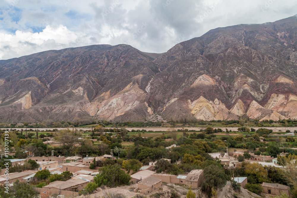 Village Maimara under colorful rock called Paleta del Pintor (Painter's Palette) in Quebrada de Humahuaca valley, Argentina