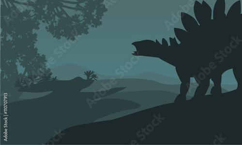 Single stegosaurus silhouette in hills