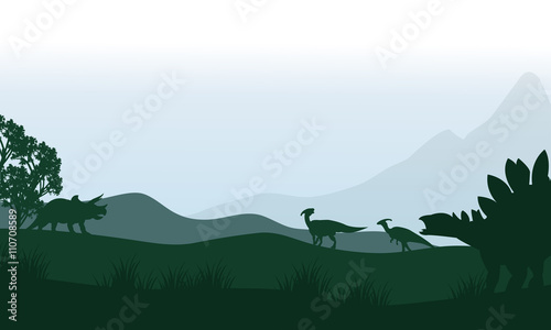 Fotografia Silhouette of stegosaurus and parasaurolophus in fields
