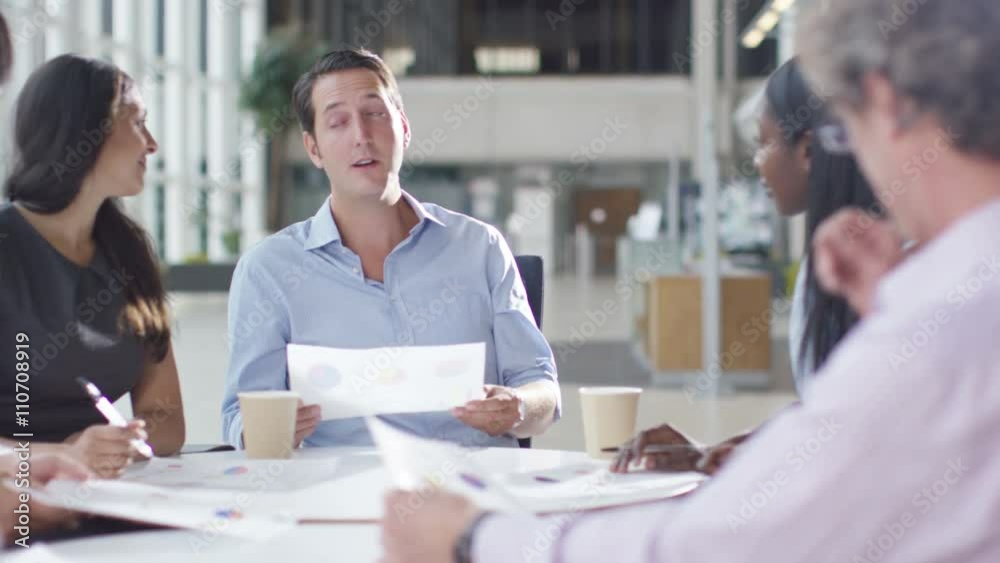 Attractive mixed ethnicity business group discuss ideas in office meeting Attractive mixed ethnicity business group discuss ideas in office meeting