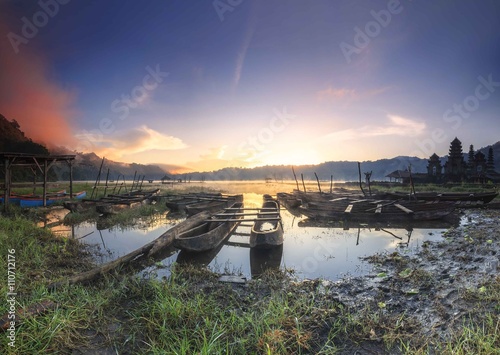 Sunrise and old boats at Lake Tamblingan, Bali, Indonesia photo