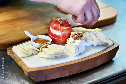 Cooking cheese plate with apple and walnut