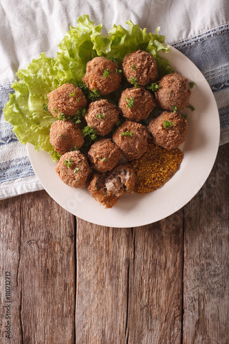 Dutch meat croquettes Bitterballen and mustard close up. vertical top view 
 photo