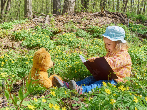 Cute girl reading book Teddy bear