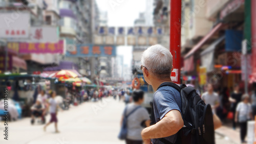 senior man with hong kong urban architecture scene photo