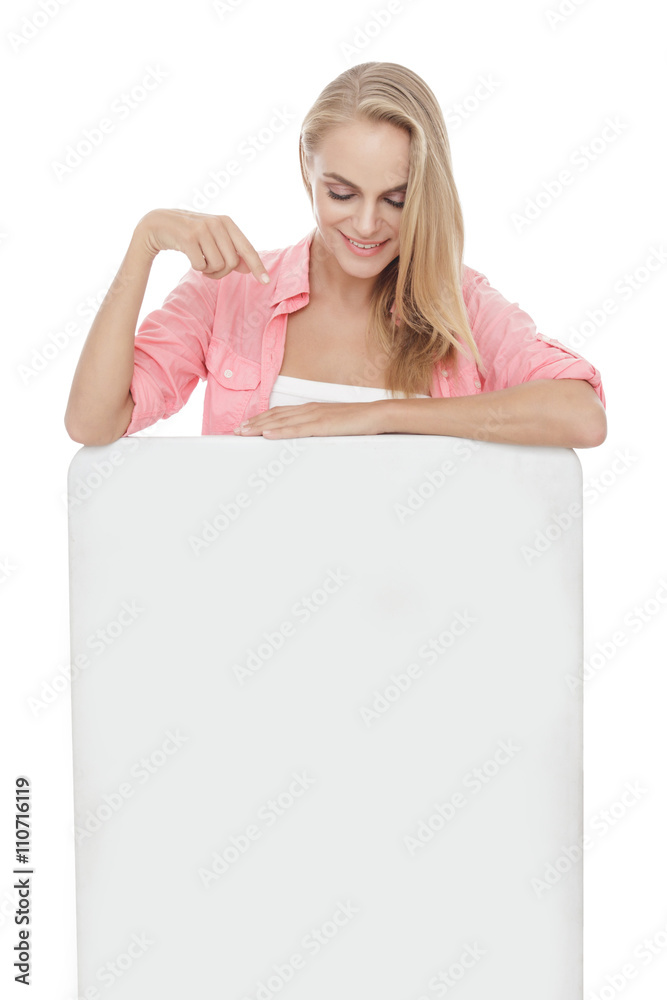 beautiful blonde woman pointing and looking at blank white board beautiful blonde woman pointing and looking at blank white board