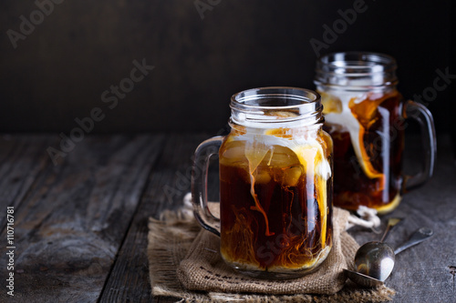 Iced coffee with milk in mason jars