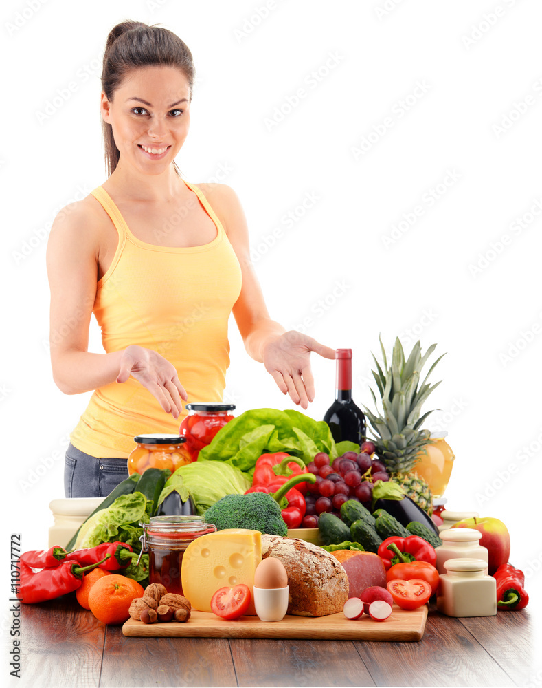 Young woman with variety of organic grocery products on white Young woman with variety of organic grocery products on white