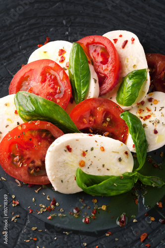 Caprese salad with mozzarella, fresh tomato and basil
