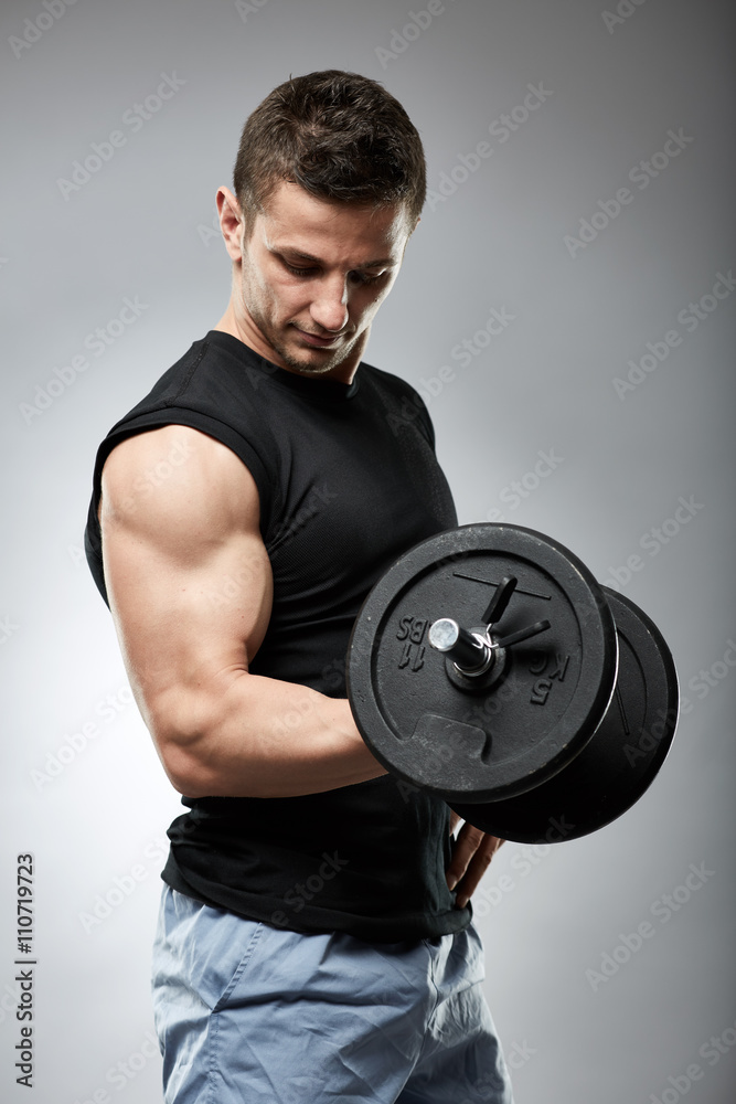 Biceps curl with dumbbell on grey background Biceps curl with dumbbell on grey background