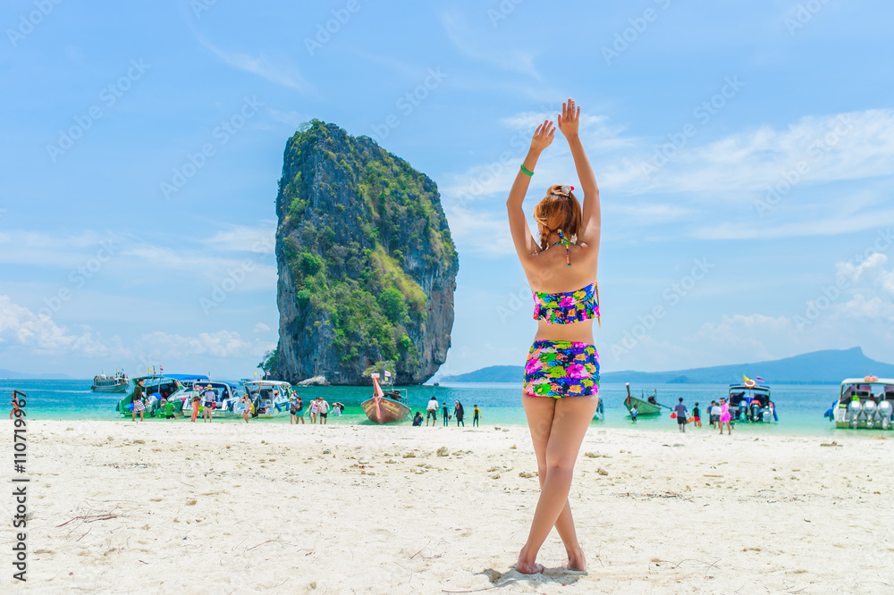 Beautiful woman relexing on the beach. Poda island. Thailand
