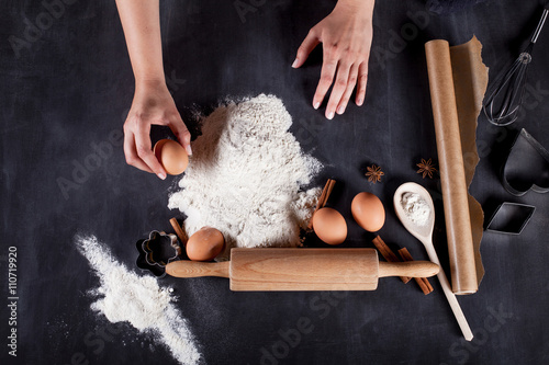 Cook preparing cookies from eggs, flour, cinnamon and anise