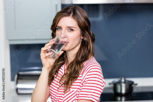 Portrait of beautiful young woman drinking water