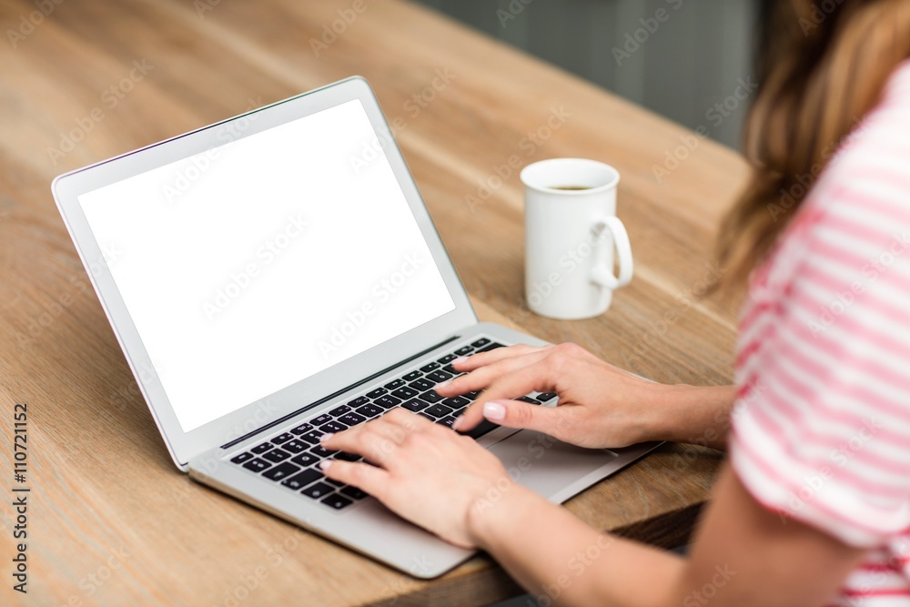 Cropped image of woman typing in laptop