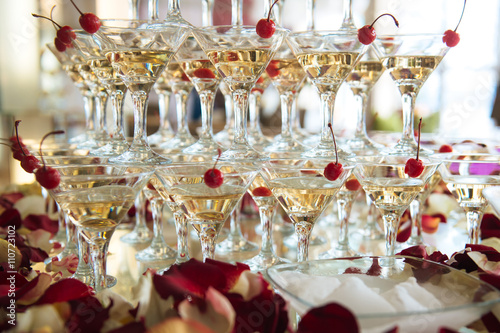 Close-up of the champagne pyramid with a red cherry at the top of each glass