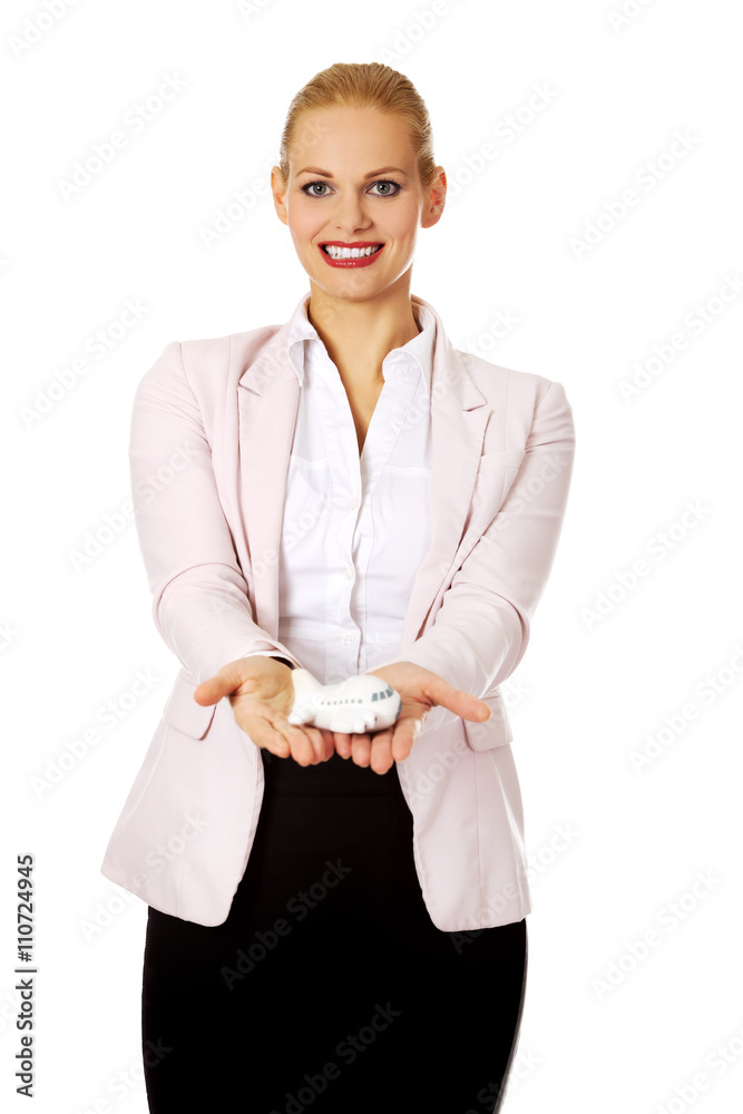 Beautiful business woman holding airplane model Beautiful business woman holding airplane model