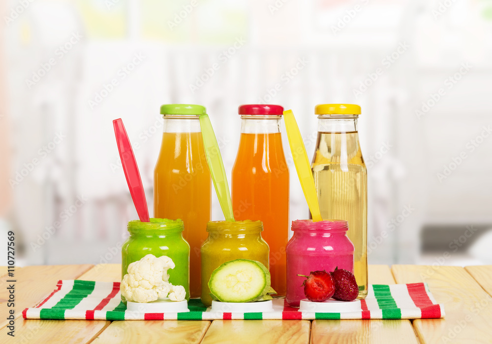 Jars and bottles baby puree juice isolated on white background. Jars and bottles baby puree juice isolated on white background.