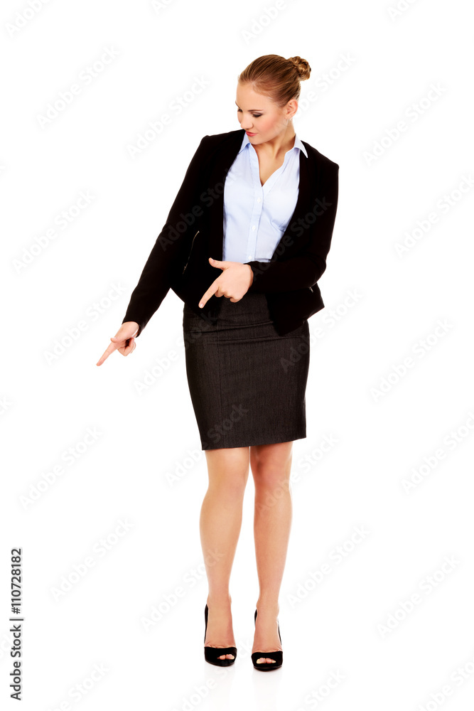 Young beautiful business woman pointing down Young beautiful business woman pointing down
