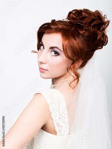 beautiful bride in a wedding dress with a wedding makeup and hairstyle