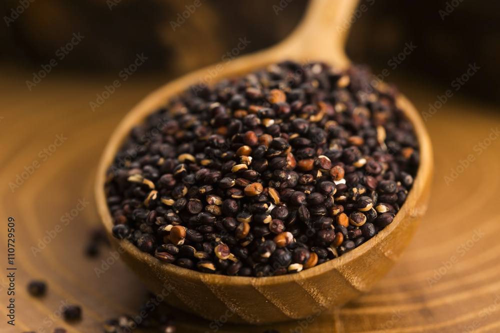 Black quinoa seeds on a wooden background Black quinoa seeds on a wooden background