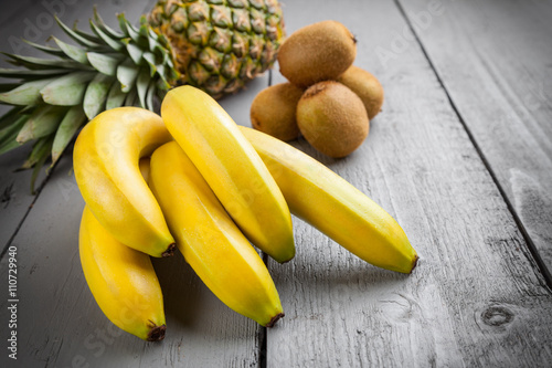 Delicious exotic fruit on grey wooden background photo