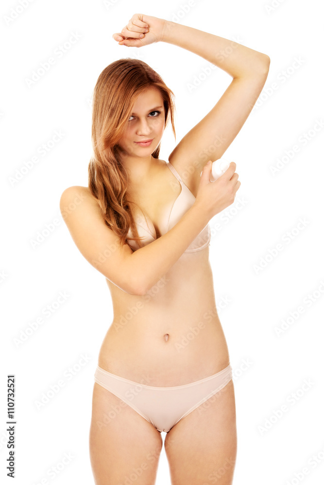 Beautiful young woman using antiperspirant Beautiful young woman using antiperspirant