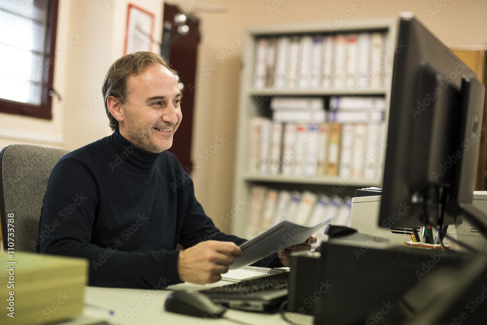 Smiling adult man with folder in hands Smiling adult man with folder in hands