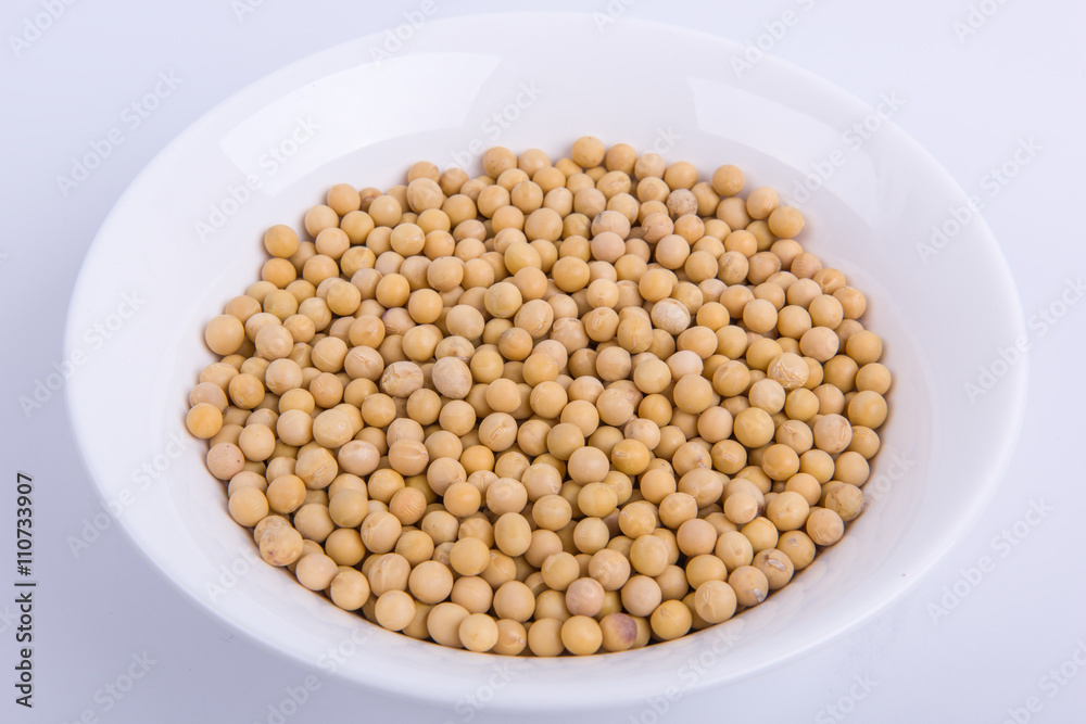 Soybeans in a white bowl isolated on white background.