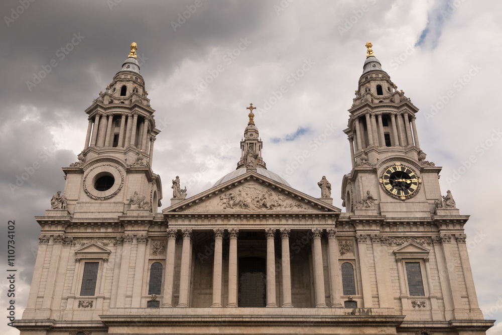 The west front upper part of St Paul's Cathedral which sits at the highest point of the City of London, UK on the cloudy sky day. The most famous public place for tourist.