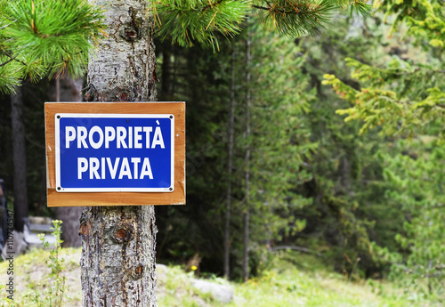 A rustic private property sign in a wooded area near Andraz Castle, Dolomites Mountains, Italy, sept. 2015 photo