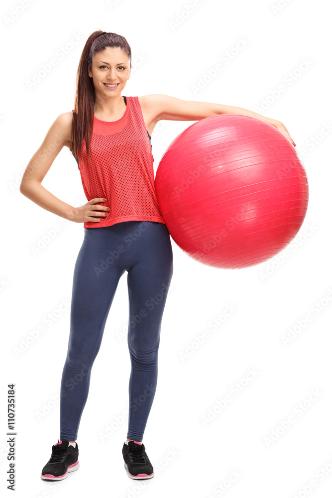 Woman in sportswear holding a fitness ball Woman in sportswear holding a fitness ball