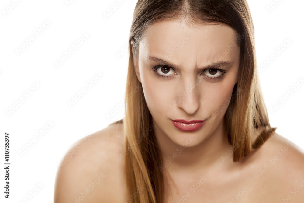 angry young woman with a raised eyebrow angry young woman with a raised eyebrow
