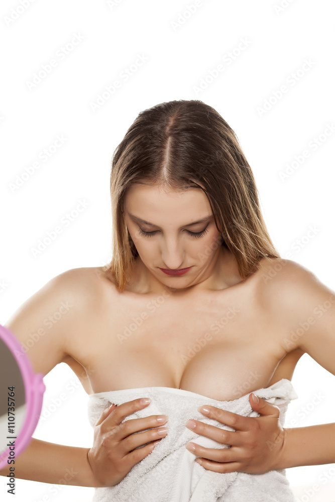 young woman looking and squeezing her breasts and cleavage Stock