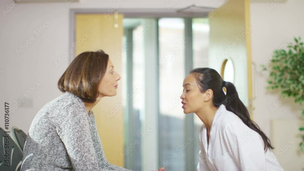  Worried woman sits alone in hospital waiting area 
