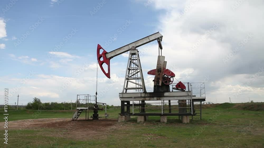 the oil pump is pumping oil. Cloudy sky.