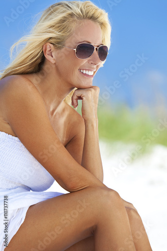 Beautiful Blond Woman in White Dress and Sunglasses At Beach © Darren Baker