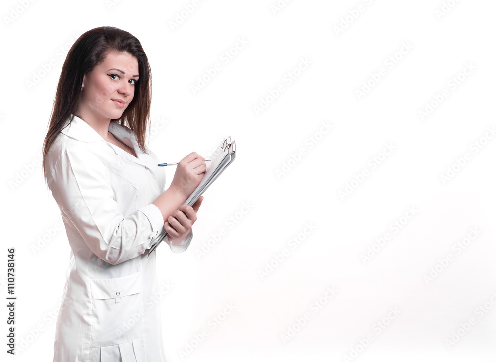 Young female doctor writing on clipboard Young female doctor writing on clipboard