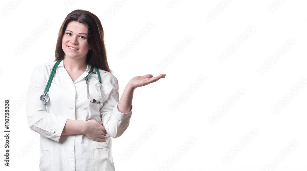 Happy smiling young beautiful female doctor showing blank area Happy smiling young beautiful female doctor showing blank area