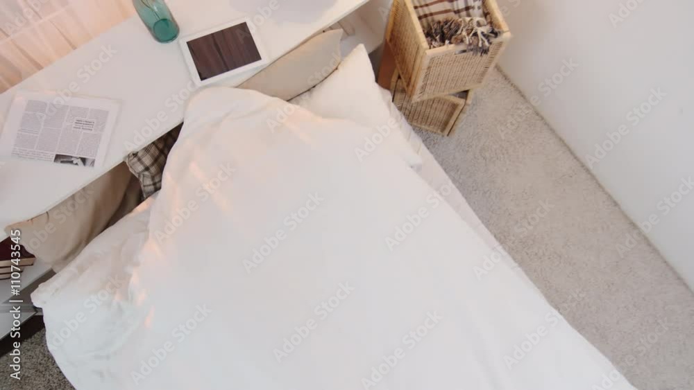 Directly above view of man and woman going to bed and lying down under blanket