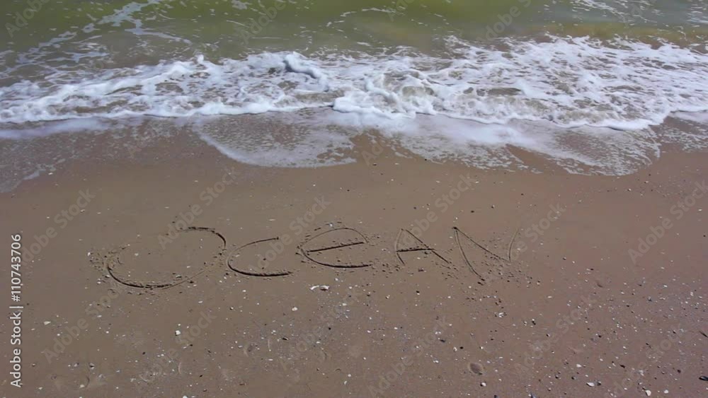 Word OKEAN writing on sand beach. Word OKEAN writing on sand beach.