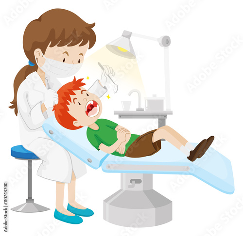 Boy having teeth checked by dentist