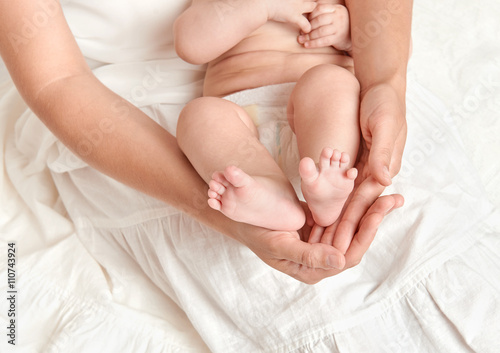 baby feet in mother hand  health care concept  body and skin