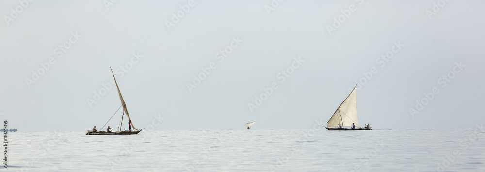 Fototapeta premium Traditional fisherman boat in Zanzibar on ocean with rainy cloud