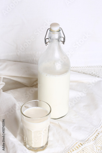 glass of milk  bottle  white linen background rustic style advertising eco products