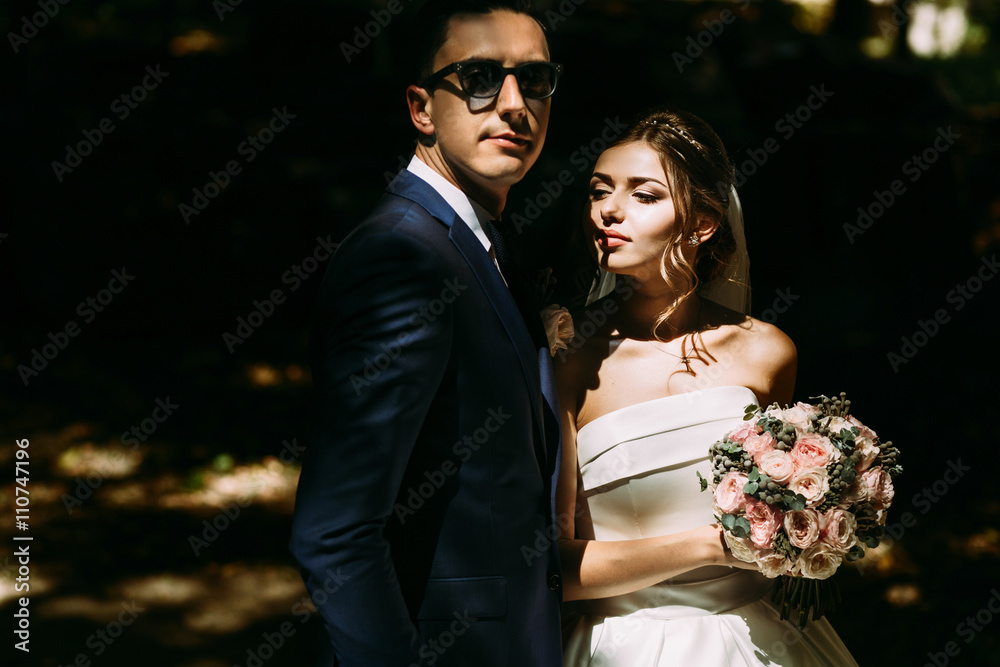 Beautiful bride and her groom in the sunglasses