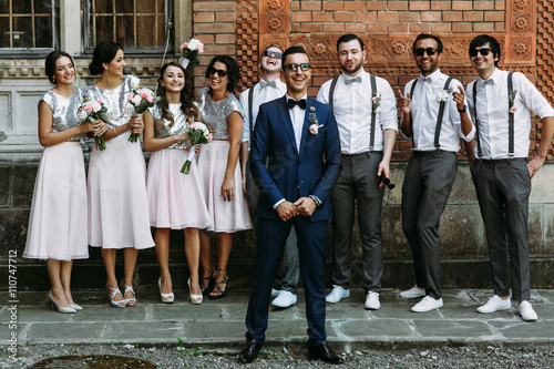 Groom in the sunglasses and his friends behind photo