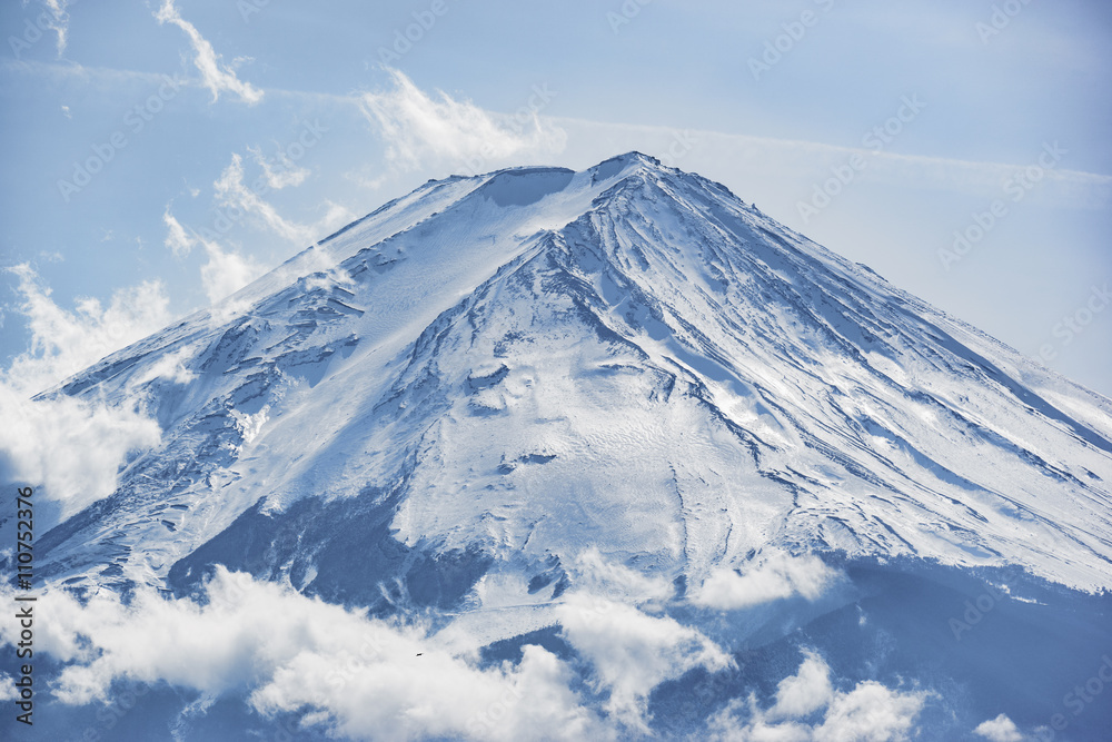 Close up to the  top fuji mountain in winter with clear blue sky and white cloud, Japan 